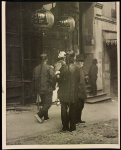 Chinese American men and child in front of building with hanging lanterns, Chinatown, San Francisco LCCN2015650744 photo