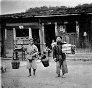 Chinese coolies carry their burdens