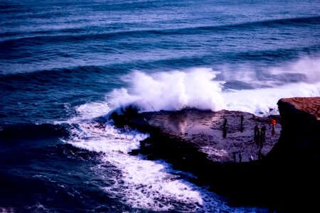 Figures crashing waves nature