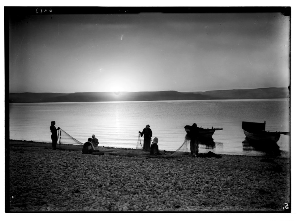 Choice set of thirteen slides, illustrating the Sea of Galilee and its fishermen still 'toiling with their nets.' Mending nets at dawn LOC matpc.05685