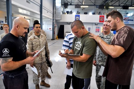 Chris Lytle and Matt Mitrione sign autographs at the gym during a visit to Camp Atterbury, Indiana, Sept. 20-2011 (110929-A-GI410-168)