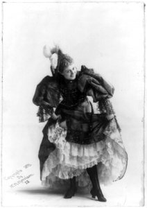 Cissy Fitzgerald, full length, standing, curtsying, facing right; coquettishly holding up skirts to show fancy slips LCCN2005677896