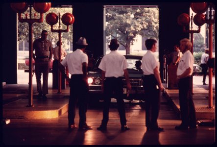 City Employees Watch the Approach of a Car for a Headlight Alignment Check at an Auto Emission Inspection Station in Downtown Cincinnati, Ohio...08-1975 (4266538570)