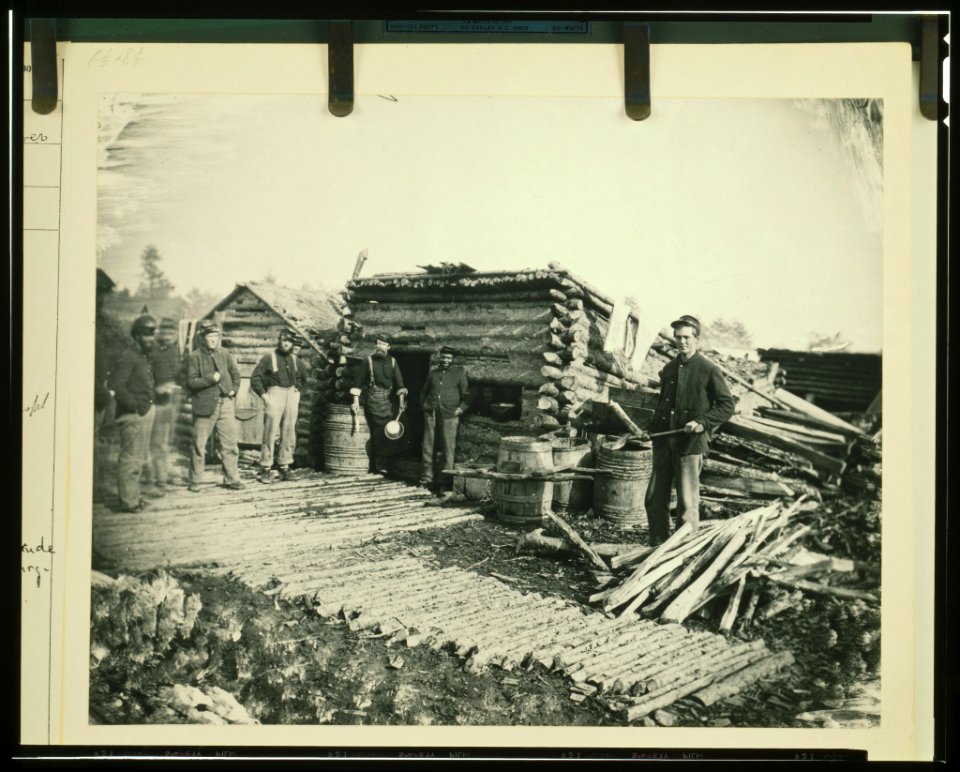 Civil War camp of the 6th N.Y. Artillery at Brandy Station, Virginia, showing Union soldiers in front of log company kitchen LCCN92507185