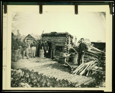 Civil War camp of the 6th N.Y. Artillery at Brandy Station, Virginia, showing Union soldiers in front of log company kitchen LCCN92507185