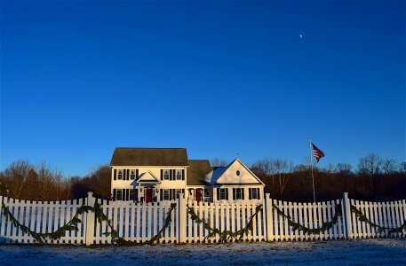 White picket fence dusk twilight photo