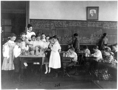 Classroom scene in Washington, D.C. elementary school - children working with blocks and at blackboard in mathematics class LCCN2001703711