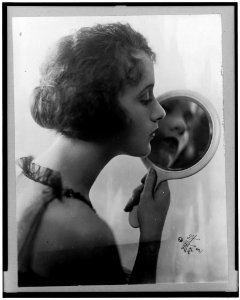 Constance Talmadge, head-and-shoulders portrait, facing right, looking into mirror LCCN96500343