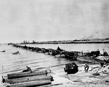 Construction of Mulberry harbor bridges following landing, Normandy Invasion, June 1944 (28321656728)