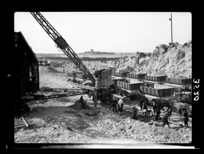 Construction of the Haifa harbour. The Athlit quarries. Loading a train. Athlit ruins in back(g)round LOC matpc.15383
