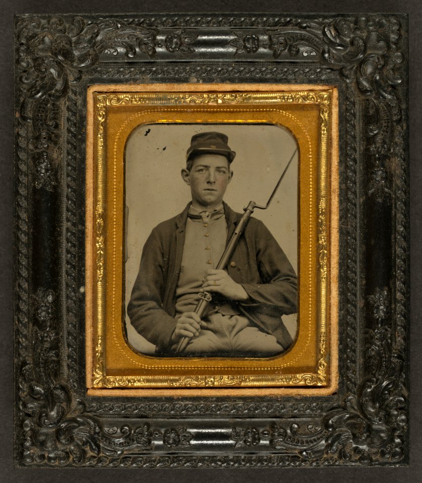 Corporal John A. Hartshorn of Company A, 19th Maine Infantry, in Union uniform sitting with bayoneted musket) - From Walton's Ambrotype & Photograph Rooms, corner of Merrimack and Pecker LCCN2010648796