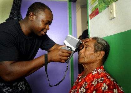 Corpsman gives eye exam to man in Tonga during Pacific Partnership. (5622924986) photo