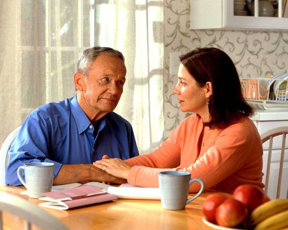 Couple sitting at a kitchen table (1)