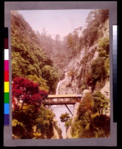 Covered bridge in a steep gorge, with waterfalls in the background, in Japan LCCN93500181