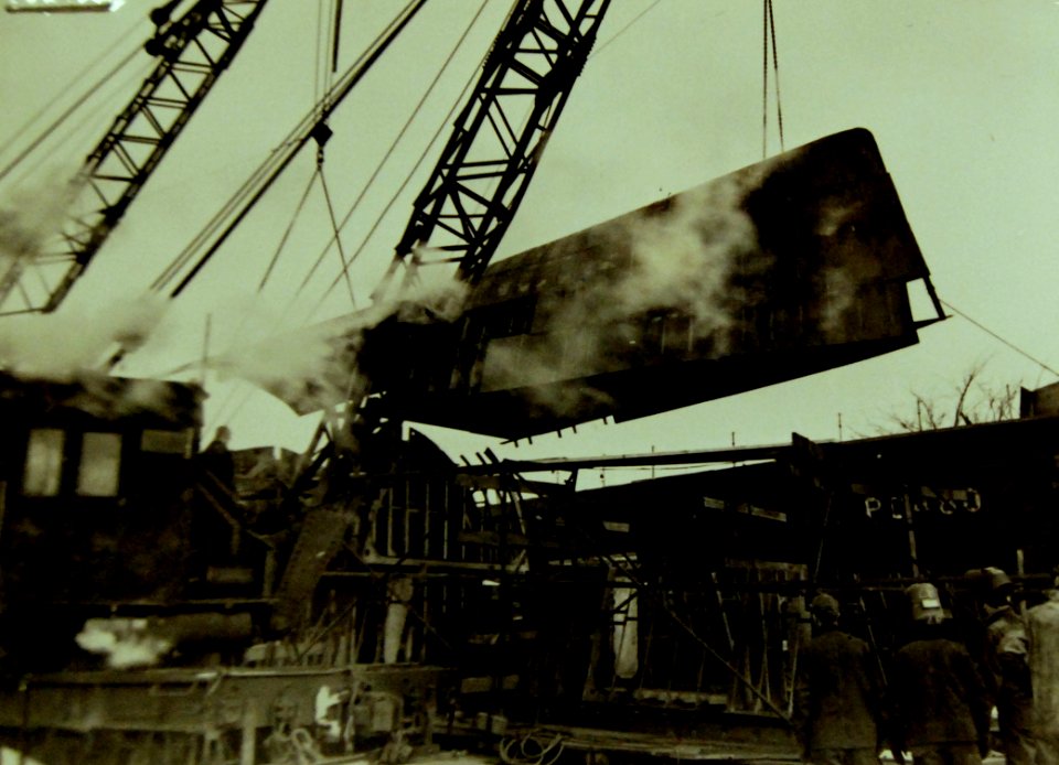 Crane swinging the hull section of a submarine chaser into place, 1942 (21903450222)