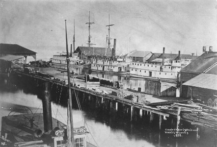Crawford, Harrington and Yesler's wharves, looking west toward Elliott Bay, Seattle, 1882 (PEISER 143)