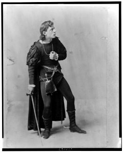Creston Clarke, full-length portrait, facing right, standing, holding sword, as a character in a play LCCN2001700497