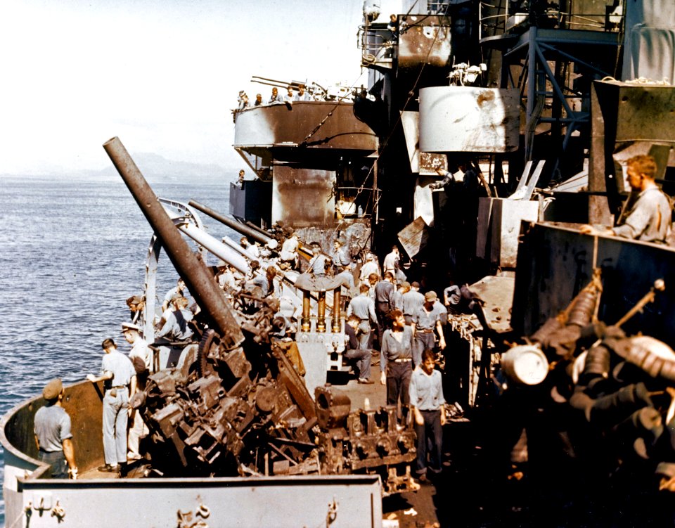 Crewmen cleaning Kamikaze damage on USS Nashville (CL-43) in December 1944