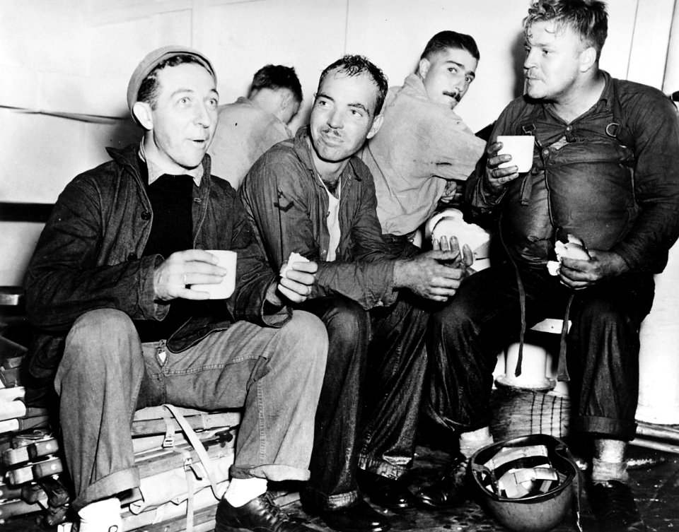 Crewmen on USS Boston (CA-69) eating after repelling enemy air attack off Formosa, 14 October 1944 (80-G-272639)
