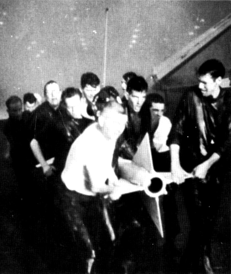 Crewmen remove Sparrow missile from fire on USS Forrestal (CVA-59) 1967