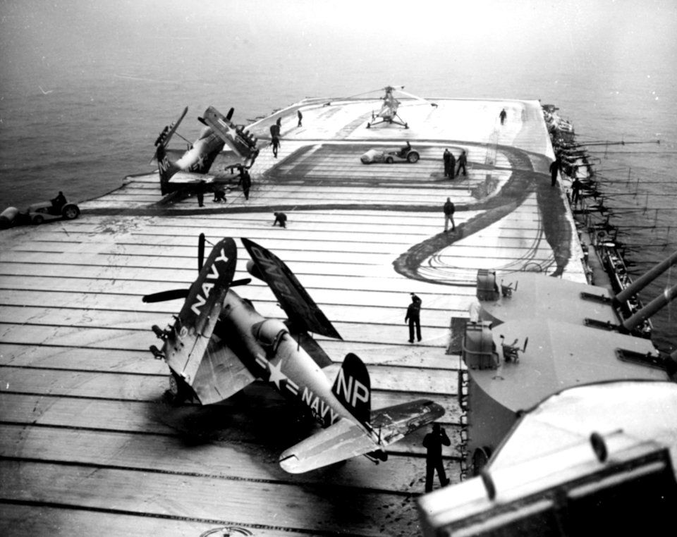 Crewmen sweep snow from the flight deck of USS Valley Forge (CV-45) off Korea, circa early 1951 (80-G-428267)
