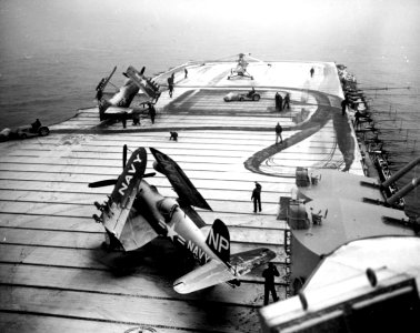 Crewmen sweep snow from the flight deck of USS Valley Forge (CV-45) off Korea, circa early 1951 (80-G-428267)