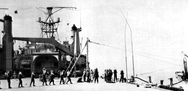 Crewmen on the flight deck of USS Cleveland (LPD-7) during an underway replenishment, circa in 1967