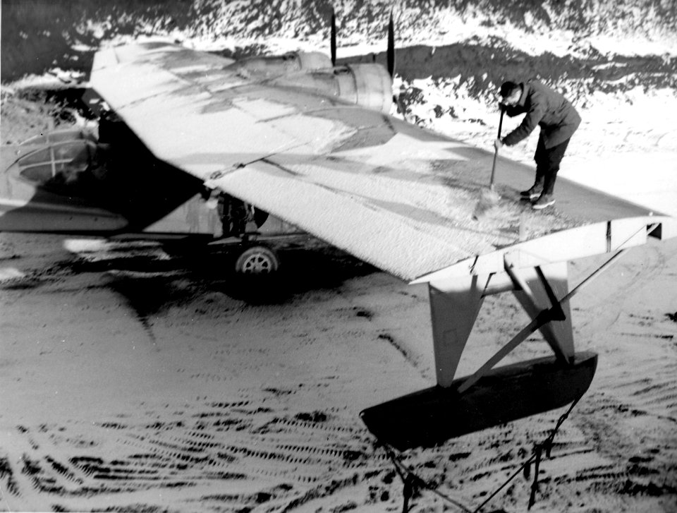 Crewmen removes snow from PBY in Alaska c1943