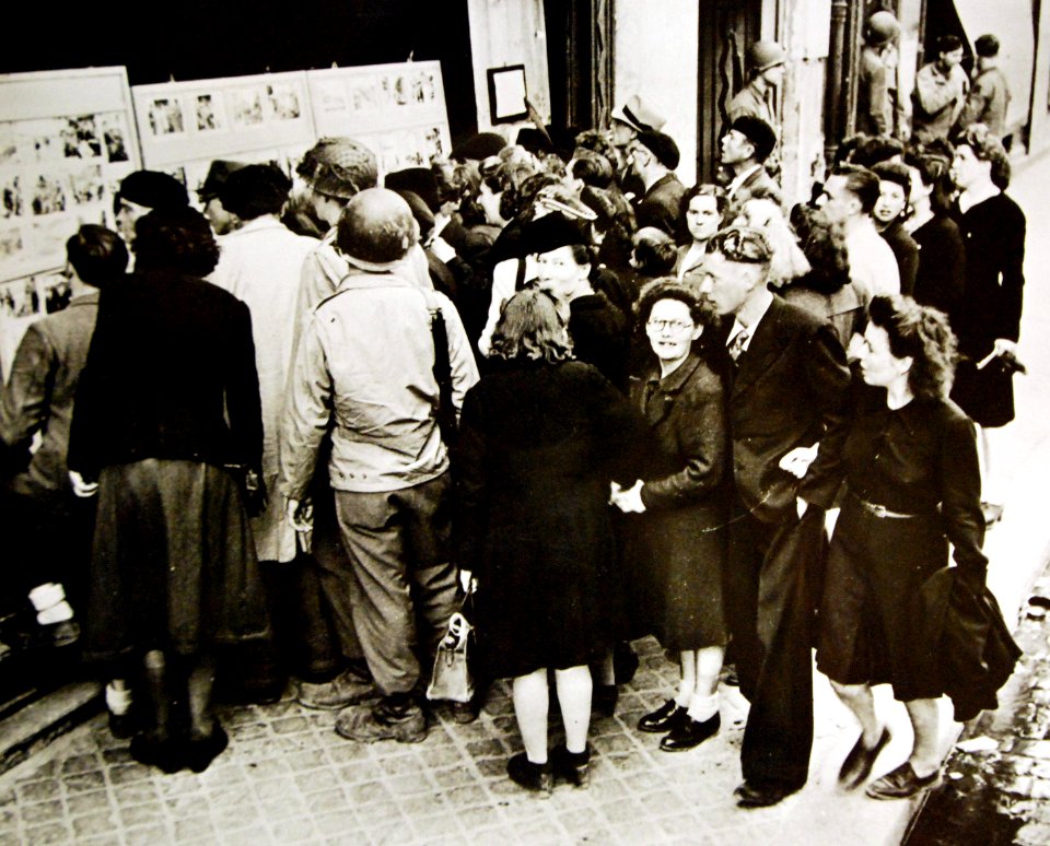 Crowd gathers before Allied picture display, Cherbourg, France, 1944 (24892519219)