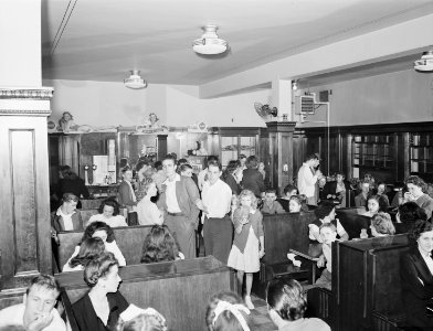 Crowd of miners and families in soda fountain prior to movie showing Saturday night. Inland Steel Company... - NARA - 541424