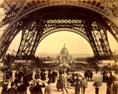Crowd of people walking under the base of Eiffel Tower, view toward the Central Dome, Paris Exposition, 1889 photo