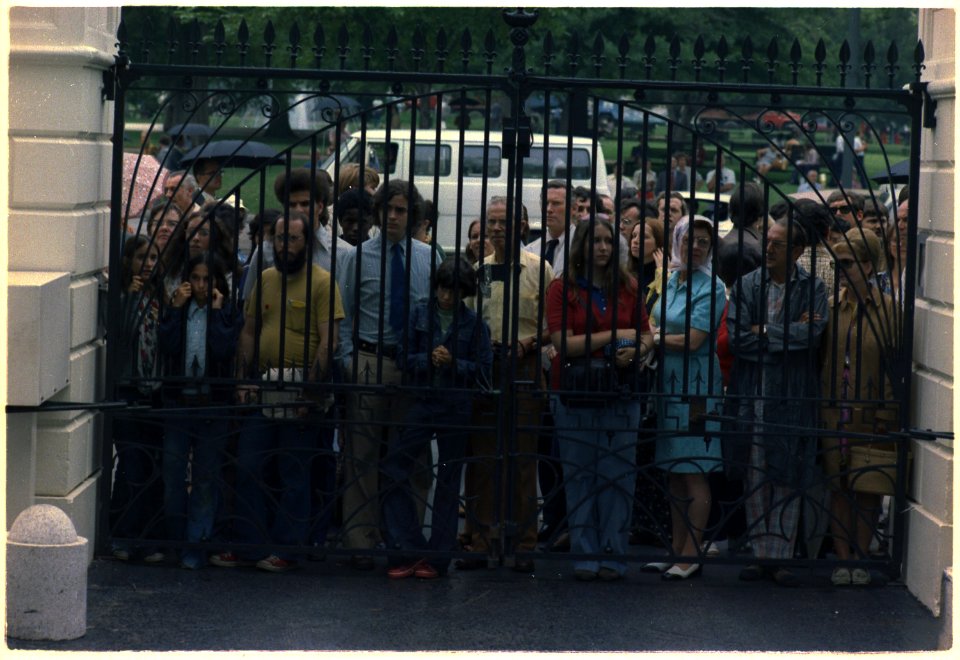 Crowd staning outside the White House gate the day of Richard M. Nixon's resignation. - NARA - 194595