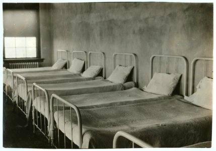Crowded dormitory (one wall) in Training School for Deaf Mutes. See Gibbons report. LOC nclc.05252