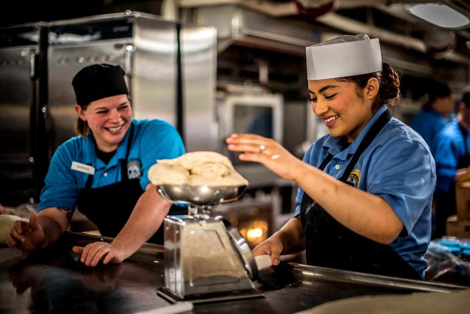 Culinary Specialists measure and prepare bread dough in the galley aboard USS Theodore Roosevelt. (34158828655)