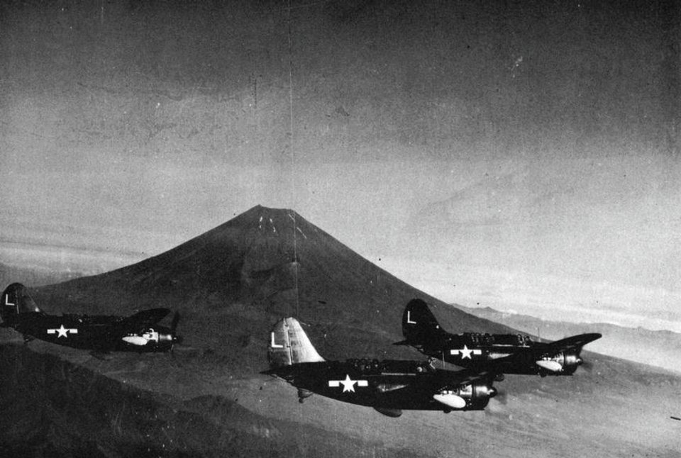 Curtiss SB2C Helldivers of VB-16 fly past Mout Fuji, Japan, in August 1945