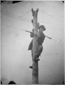 Cutting telegraph wire and connecting the ends, so that the point at which the connection is broken cannot be seen from - NARA - 519420 photo