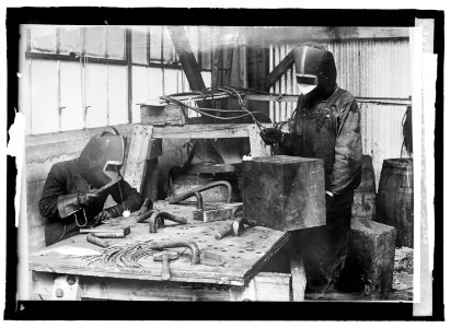 Cutting with acetylene flame, using masks & blue glass to protect the eyes LCCN2016821888