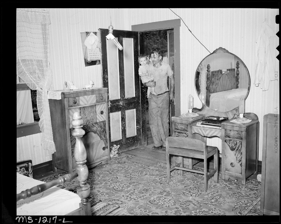 D.B. Henry, miner, entering front door of his four room house, rental $10 monthly. He has made minor repairs, painted... - NARA - 540736
