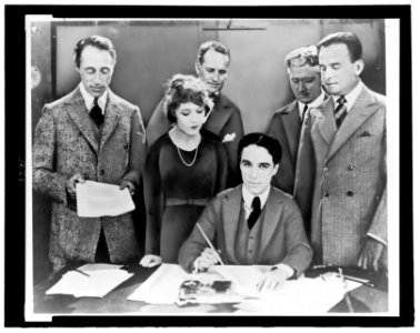 D.W. Griffith, Mary Pickford, Charlie Chaplin (seated) and Douglas Fairbanks at the signing of the contract establishing United Artists motion picture studio LCCN2007678308