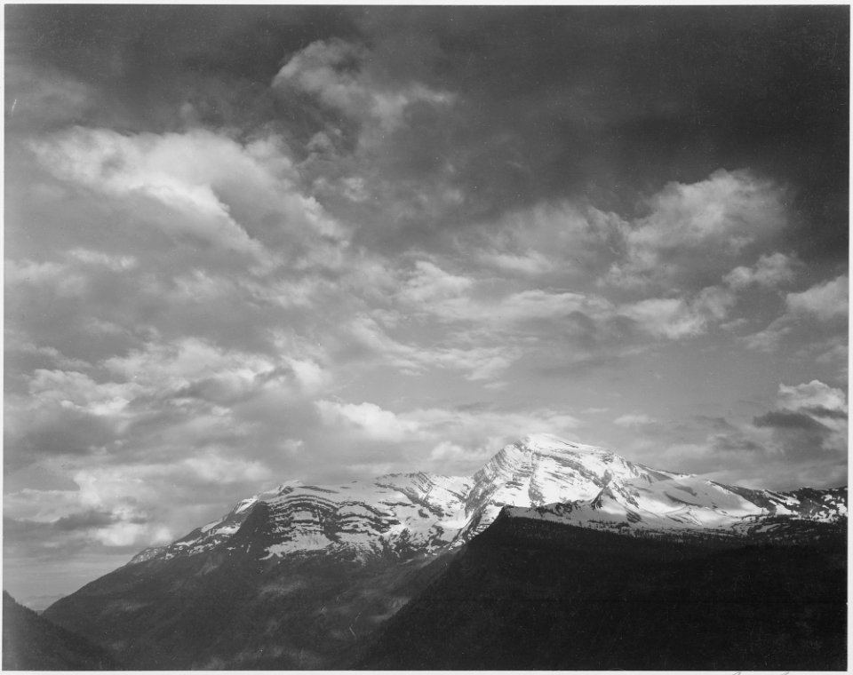Dark foreground and clouds, mountains highlighted, Heaven's Peak, Glacier National Park, Montana., 1933 - 1942 - NARA - 519871