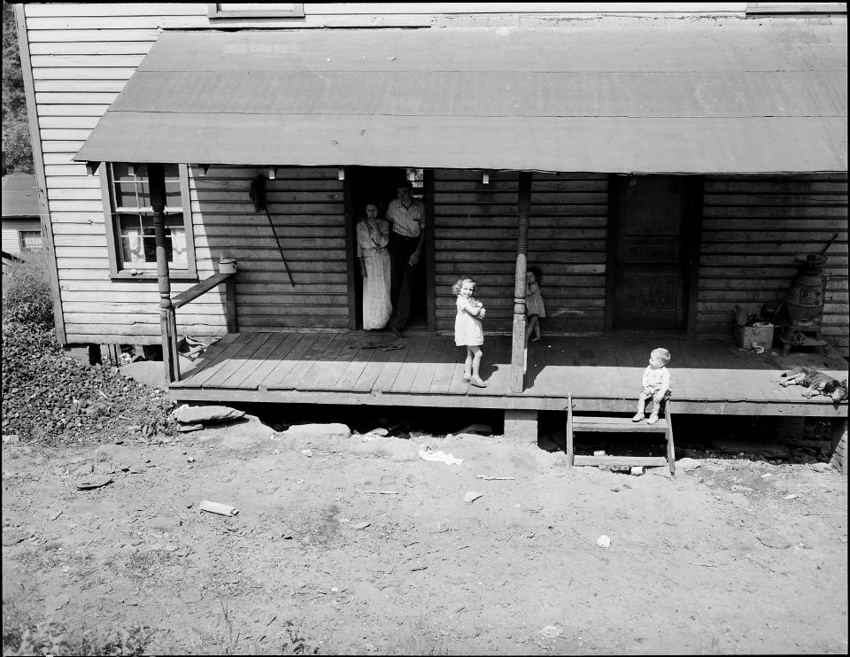 Daughter of Lewis Moncy, miner, in the kitchen, most of the houses in this camp have running water in the kitchen.... - NARA - 541030