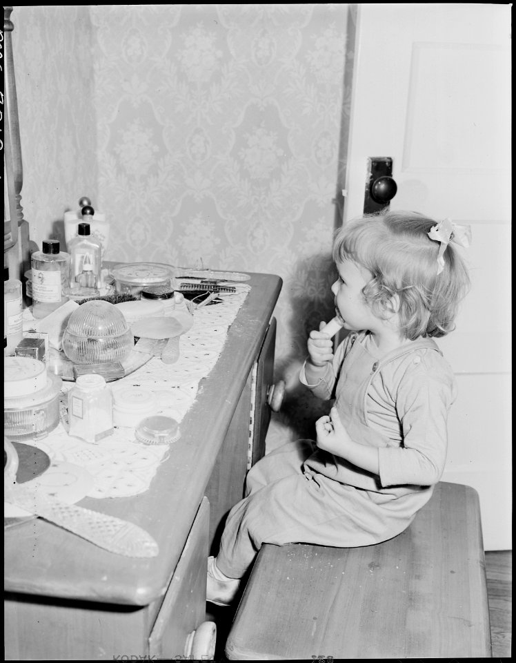 Daughter of neighbor applied lipstick in home of Harry Fain, coal miner. Inland Steel Company, Wheelwright ^1 & 2... - NARA - 541465