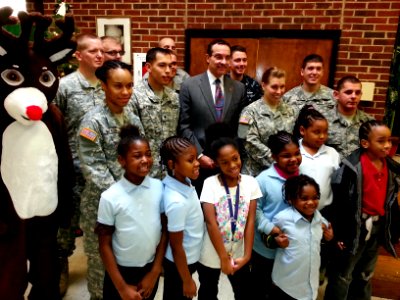 DC Mayor Vincent Gray poses with Rudolph the Red-nosed Reindeer; volunteer military and civilian workers from Joint Base Anacostia-Bolling (JBAB) 131218-N-CG900-004