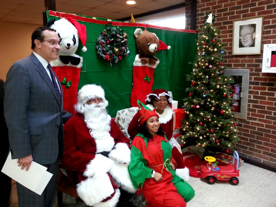 DC Mayor Vincent Gray poses for photographers after wishing a Merry Christmas to youth 131218-N-CG900-001