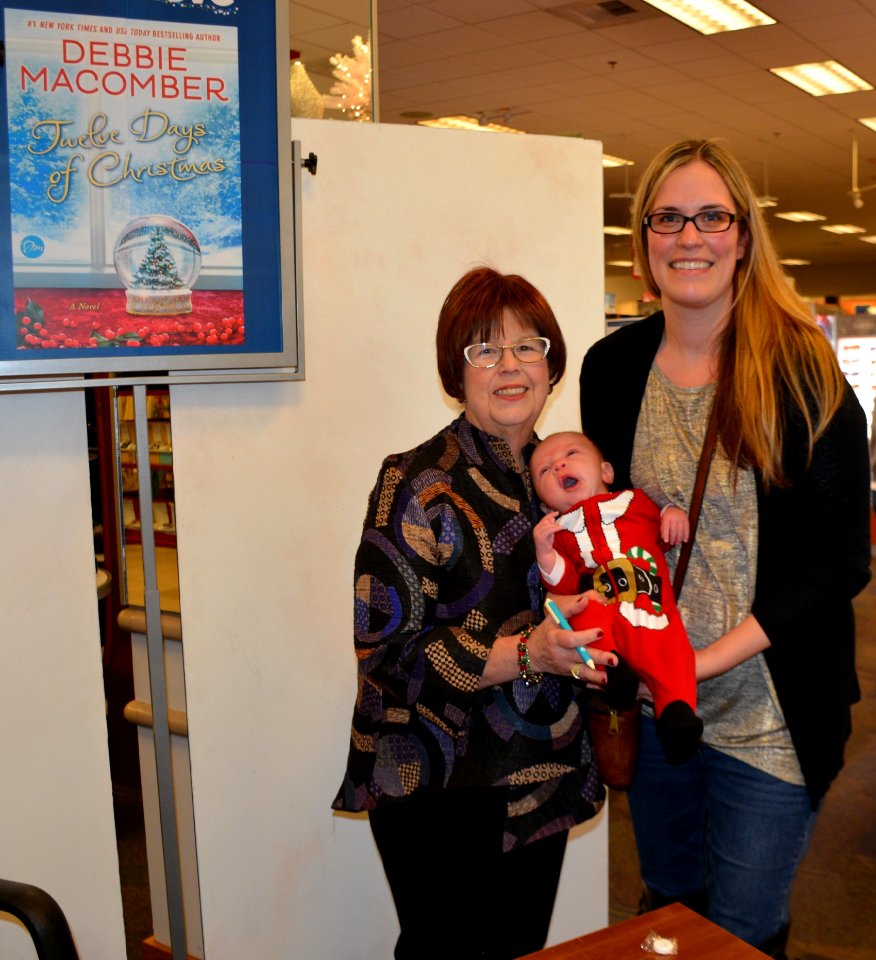 Debbie Macomber with Jacob and Annmarie Wilson 161203-N-SP496-004