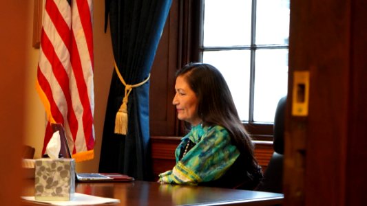 Deb Haaland with a laptop in 2019