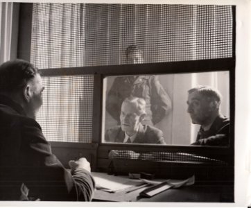 Defendant Joachim Mrugowsky consults with Dr. Fritz Flemming and Dr. Wilhelm Schmidt