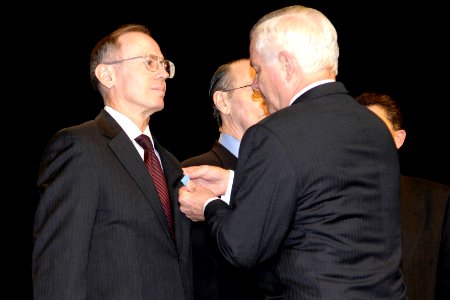 Defense Secretary Robert M. Gates congratulates Stephen A. Fleet, director, Warfighter Support Center-106