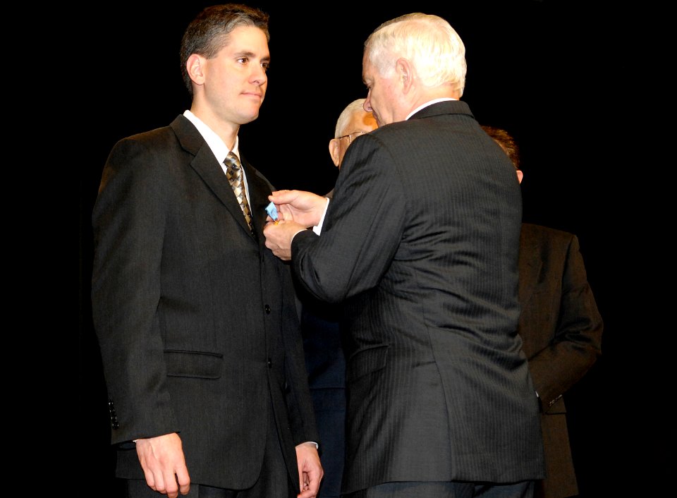 Defense Secretary Robert M. Gates congratulates Stephen A. Fleet, director, Warfighter Support Center-110