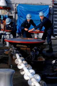 Defense.gov News Photo 100624-N-6477M-256 - U.S. Navy Petty Officer 3rd Class Ryan McLaughlin left Seaman Garrett Mann and Seaman Michael Bell right control the anchor windlass while